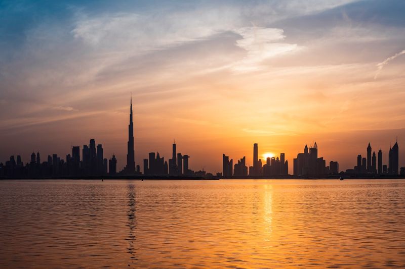 An image of the Dubai skyline at sunset
